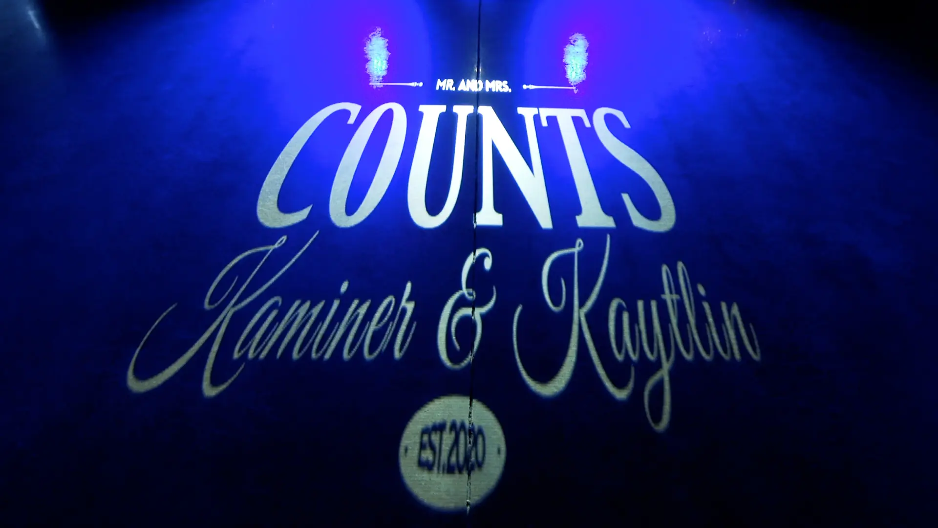 Custom wedding monogram projected in blue light